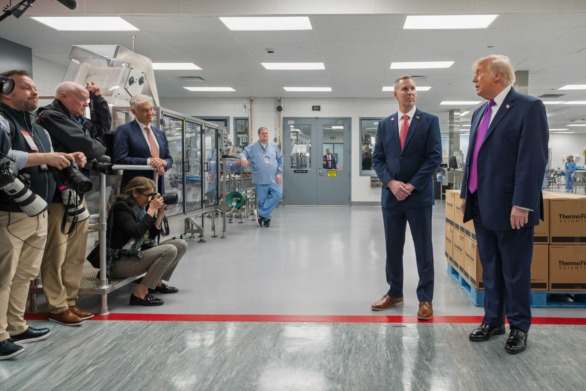 The President on the Thermo Fisher Scientific production floor as the press pool documents the visit